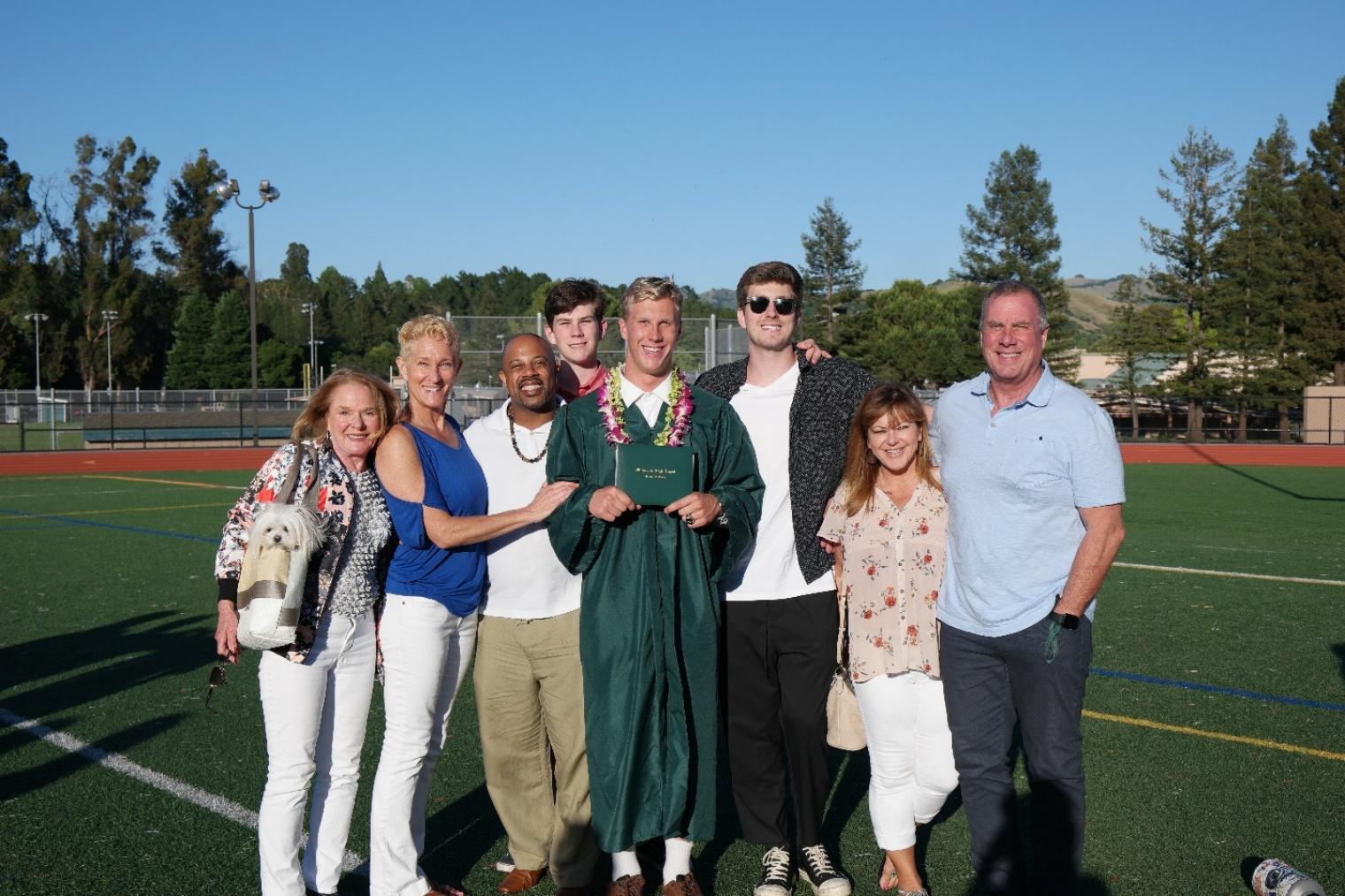 A tender black-and-white photograph of an older man cradling a young child — representing the deep family bond Laurel shared with the Strands.